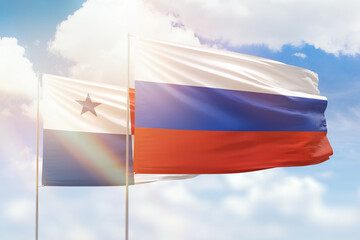 Sunny blue sky and flags of russia and panama