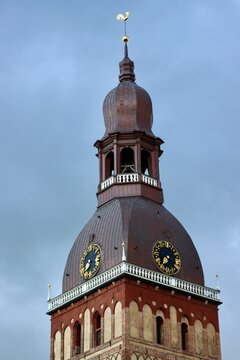 Tower of Riga Dome cathedral, Latvia, on a cloudy day with blue sky. Selective focus, vertical photo.