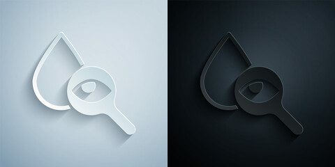 Paper cut Drop and magnifying glass icon isolated on grey and black background. Paper art style. Vector