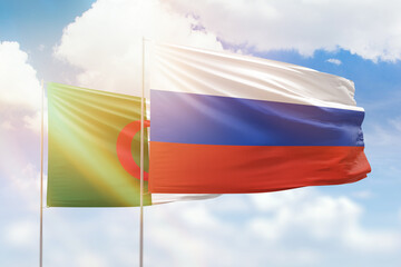 Sunny blue sky and flags of russia and algeria