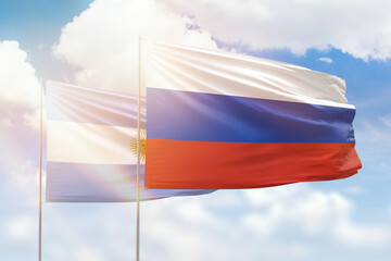 Sunny blue sky and flags of russia and argentina