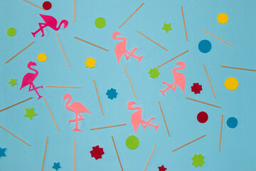 creative summer background, pastel blue with wooden sticks, colorful geometric shapes and pink flamingos, creative art tropical design