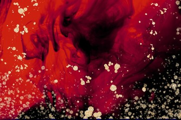 Golden drops and spatter on red and black Alcohol ink fluid abstract texture fluid art with gold glitter and liquid