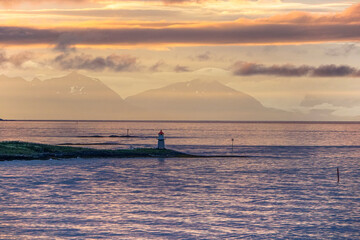 sunset on the sea with lighthouse