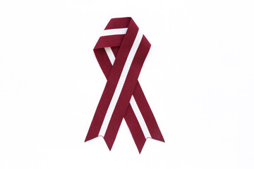 Ribbon in the colours of Latvian flag isolated on a white background.