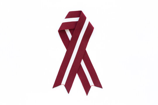 Ribbon in the colours of Latvian flag isolated on a white background.
