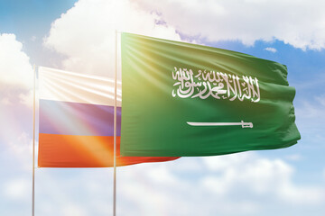 Sunny blue sky and flags of saudi arabia and russia