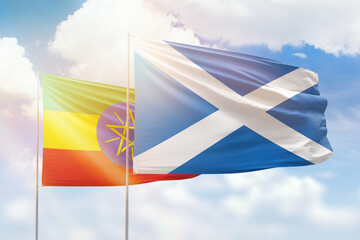 Sunny blue sky and flags of scotland and ethiopia