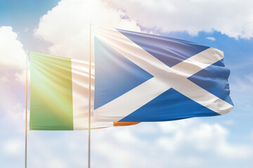 Sunny blue sky and flags of scotland and ireland