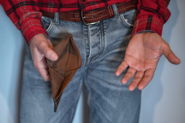 A man opens an empty wallet in close-up.