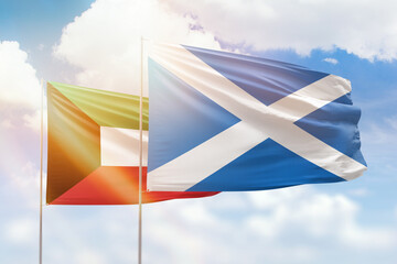 Sunny blue sky and flags of scotland and kuwait