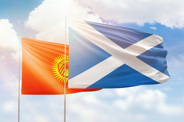 Sunny blue sky and flags of scotland and kyrgyzstan