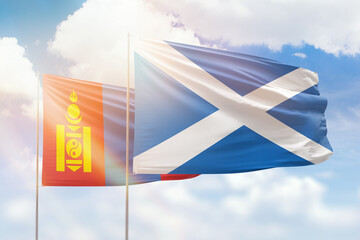 Fototapeta na wymiar Sunny blue sky and flags of scotland and mongolia