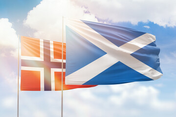 Sunny blue sky and flags of scotland and norway