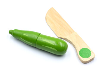 Kids toy wooden vegetables in background close up. Childrens developing wooden game. Toy tomato