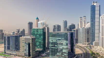 Business Bay Dubai skyscrapers with construction site aerial timelapse.