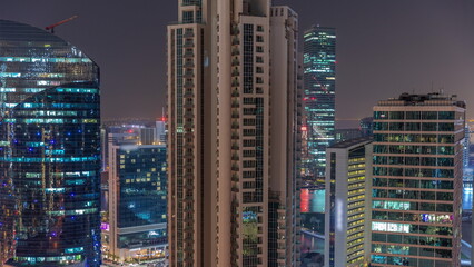 Business Bay Dubai skyscrapers with water canal aerial night timelapse.