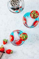 Fototapeta na wymiar Strawberry berry colada with fresh berries and blue liqueur.
