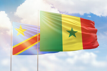 Sunny blue sky and flags of senegal and dr congo