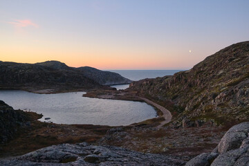 Fototapeta premium Lake in Teriberka in autumn. Colorful tundra landscape on the Kola Peninsula in autumn