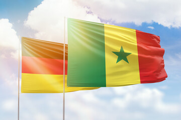 Sunny blue sky and flags of senegal and germany