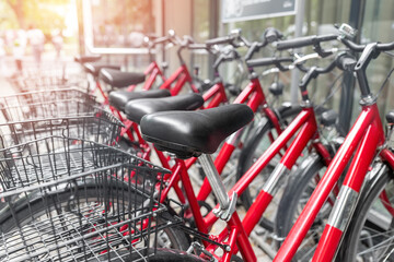 Closeup view many red city bikes parked in row at european city street rental parking sharing station or sale. Healthy ecology urban transportation. Sport environmental transport infrastructure