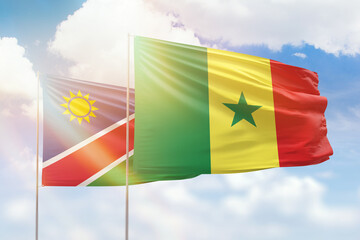 Sunny blue sky and flags of senegal and namibia