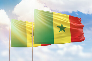 Sunny blue sky and flags of senegal and senegal