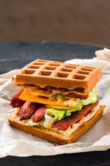 Waffle waffles with grilled sausages and fresh vegetables