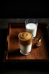 Two glasses of dalgona coffee (whipped instant coffee with milk) made with almond milk