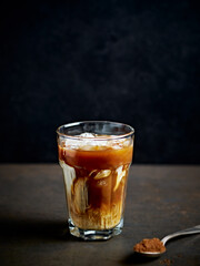 Glass of iced coffee with milk. Copy space