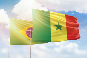 Sunny blue sky and flags of senegal and brazil