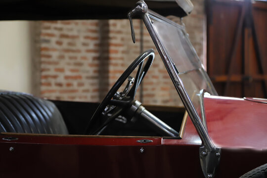 Museum of Industry, C&oacute;rdoba, Argentina. Classic cars. Automobiles. Old cars. Renault NN1. NN. Red car. Close up. Steering wheel.