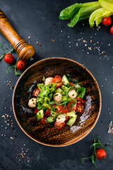 Healthy vegetable salad of fresh tomato, cucumber, lettuce on plate. Diet menu
