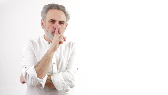 mature bearded man makes thinking gesture and raises his eyebrow medium shot white background copy space . High quality 4k footage