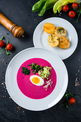 Vegan food, summer cold Beetroot soup with fresh herbs copy space top view