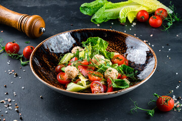 Healthy vegetable salad of fresh tomato, cucumber, lettuce on plate. Diet menu