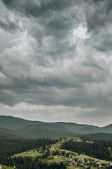 Obraz premium The rain starts in the mountains. Dark rain clouds covered the sky in Goah in summer.