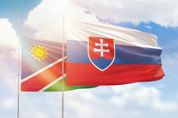 Sunny blue sky and flags of slovakia and namibia