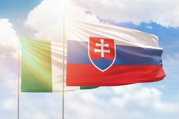 Sunny blue sky and flags of slovakia and nigeria