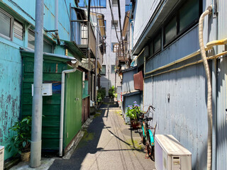 Nostalgic back alley of Japanese old folk houses behind a new building