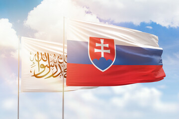 Sunny blue sky and flags of slovakia and afghanistan