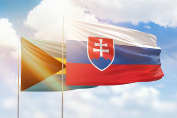 Sunny blue sky and flags of slovakia and bahamas