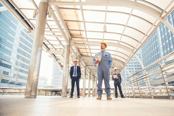 Civil engineer teams meeting working together wear worker helmets hardhat on construction site in modern city. Foreman industry project manager engineer teamwork. Asian industry professional team