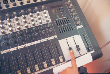 Production sound engineer hands working on recording studio mixing voice control. Expert adjusting...