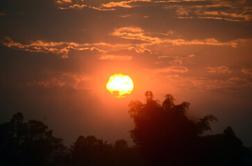 Obraz premium Scenic view dramatic beautiful sunset sky. Natural Sunset Sunrise on meadow silhouette shadow dark land. Vibrant dramatic sky on sunset, dawn, sunrise in Countryside. Landscape Colorful Sky At Sunset