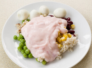 Assorted nuts and quail eggs topped with strawberry yogurt white dish