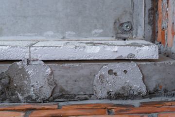 Styrofoam glued to the outer wall of the house, close-up, bottom view. Insulation of a private house