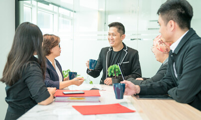 Business office colleagues discussing project over cup of coffee. Cheerful and positive vibes.