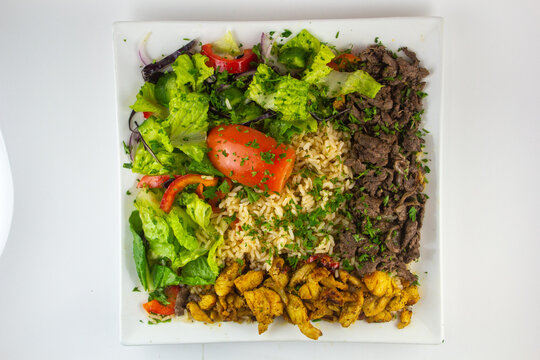 Chicken and Beef Shawarma with rice and salad. 